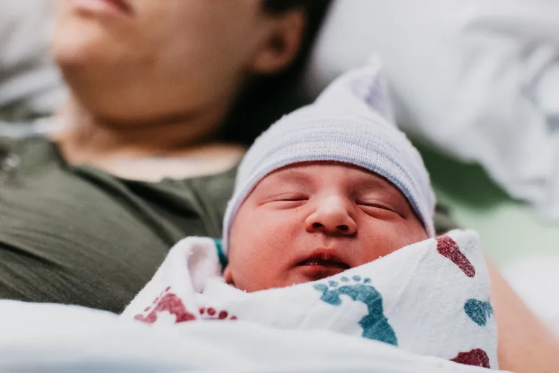 A newborn baby wrapped in a soft blanket
